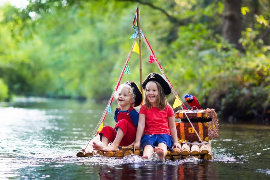 Kinderen spelen met speelgoed op het water in een bootje